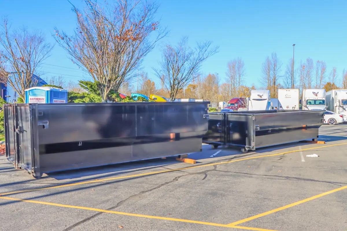 Professional dumpster rental service with roll-off container on residential driveway in Gretna